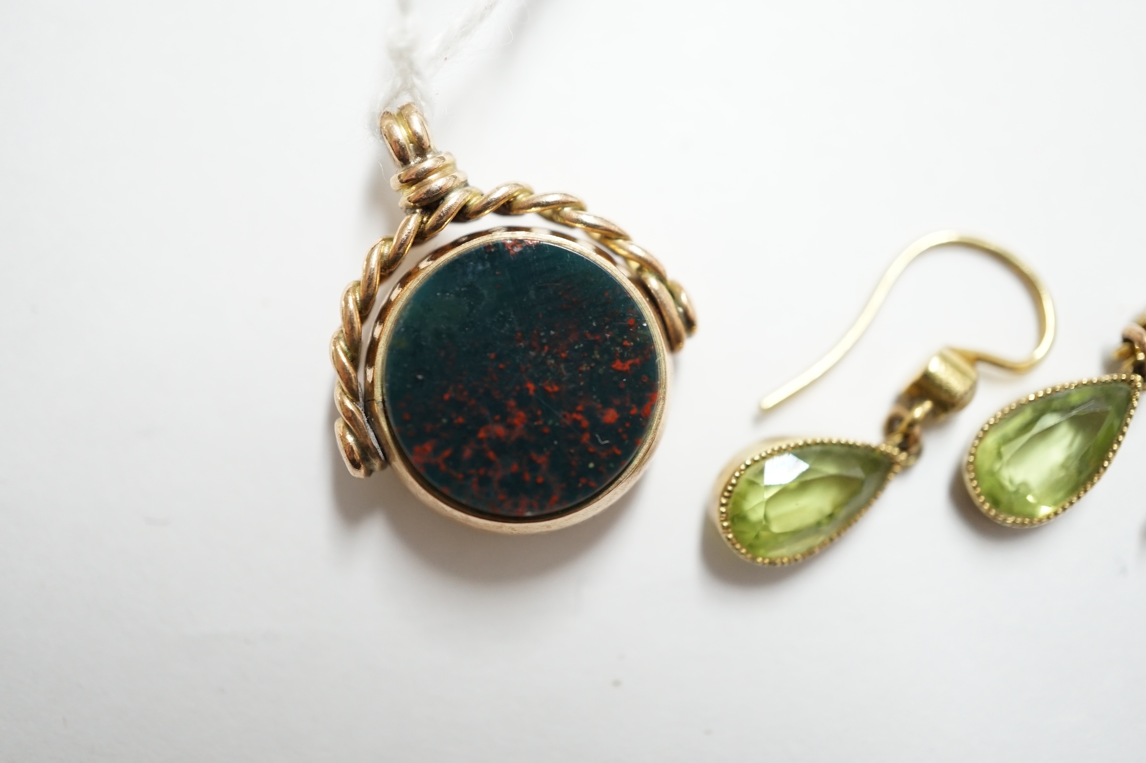 A pair of yellow metal peridot? and seed pearl set drop earrings, 11mm, together with a late Victorian 9ct gold, carnelian and bloodstone set spinning fob. Condition - fair